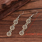 Longues boucles d'oreilles pendantes spirale
